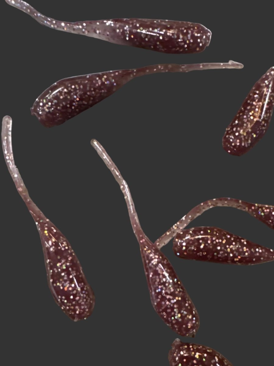 Minnow shaped soft plastic crappie jigs solid colored in a dark plum purple with silver glitter