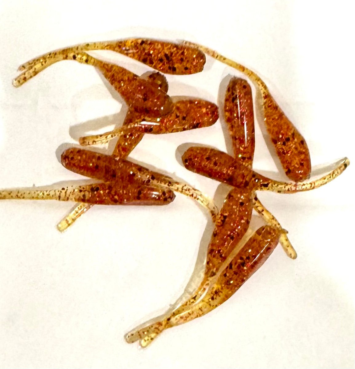 Minnow shaped soft plastic crappie jigs solid translucent honey colored body with red and black glitter