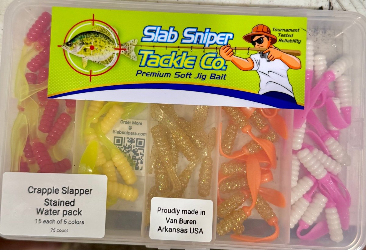 Plastic box with different colors of crappie jigs reds,greens, gold, pink, orange,and white. Slab sniper logo on the lid