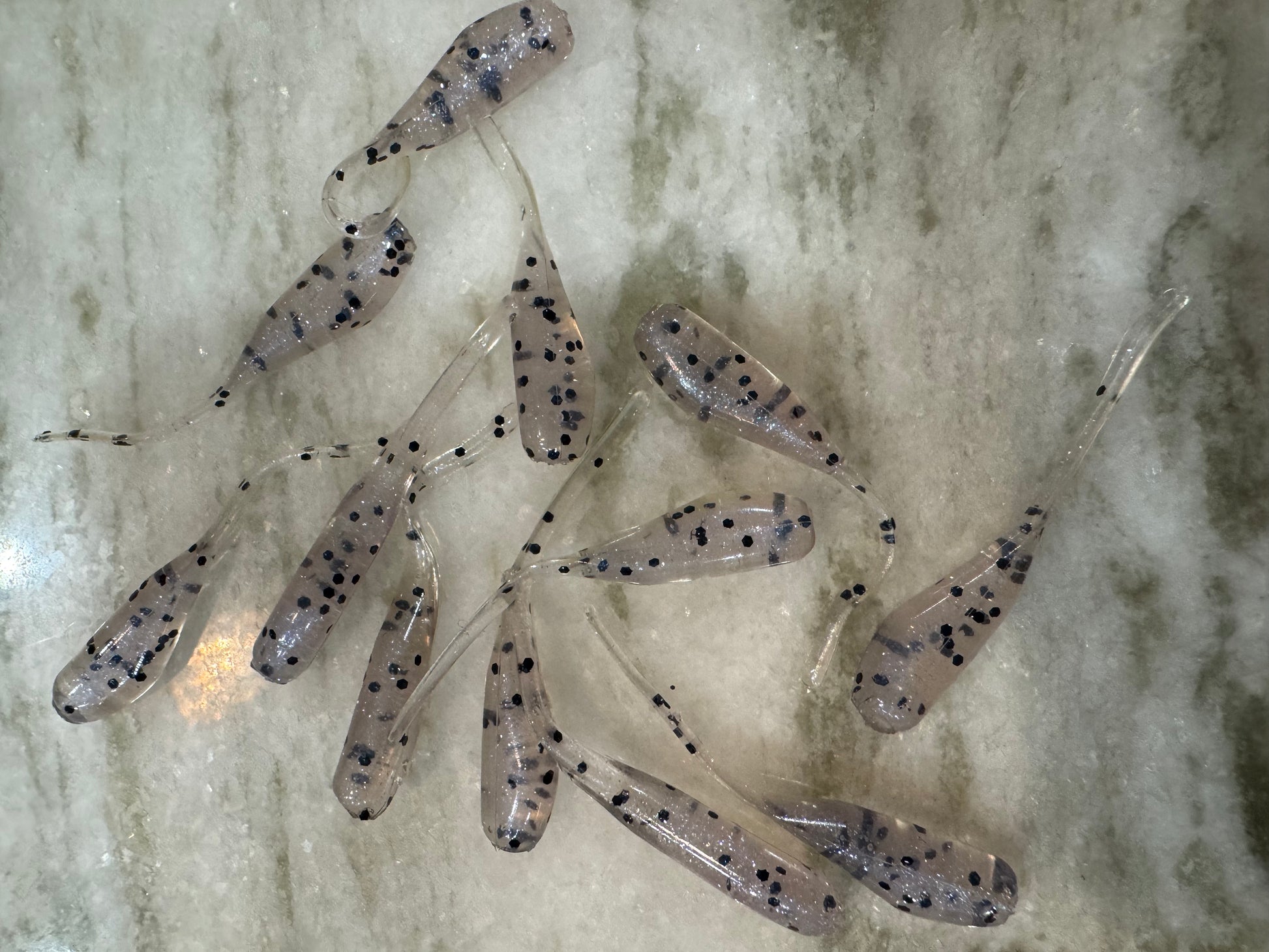 Minnow shaped soft plastic crappie jigs clear translucent body with a pearl like hue and black glitter