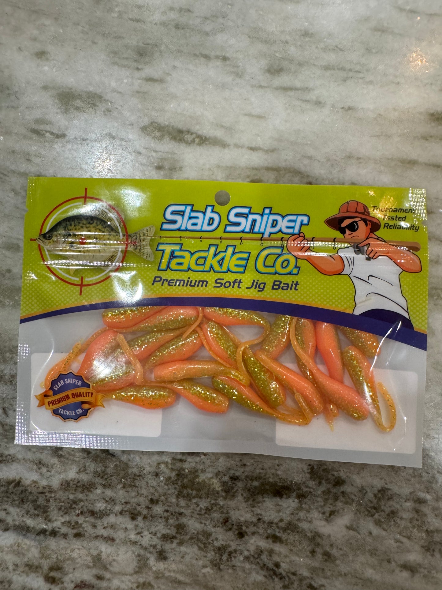 A package of Minnow shape soft plastic crappie jigs in two colors. A chartreuse green with silver glitter top and pink belly
