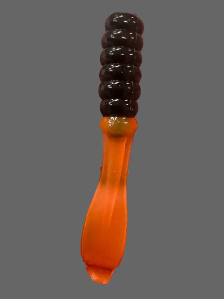 Soft plastic Crappie jig 2 inches long with a  black head and translucent orange flat beaver tail