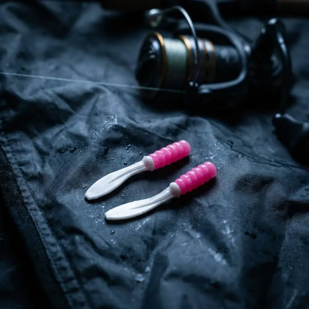 Full view of the small Crappie Slapper jig on waterproof fabric in a moody fishing environment, highlighting its slim profile and vibrant colors.