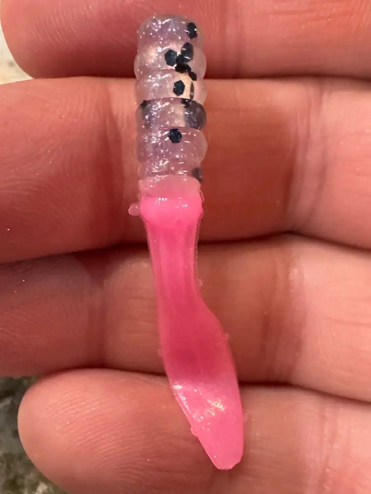 Soft plastic Crappie jig 2 inches long with a clear translucent head with black glitter and pearl pink flat beaver tail