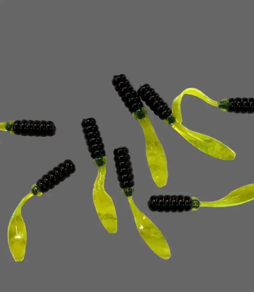 Multiple Soft plastic Crappie jig 2 inches long with a black head and a translucent chartreuse flat beaver tail