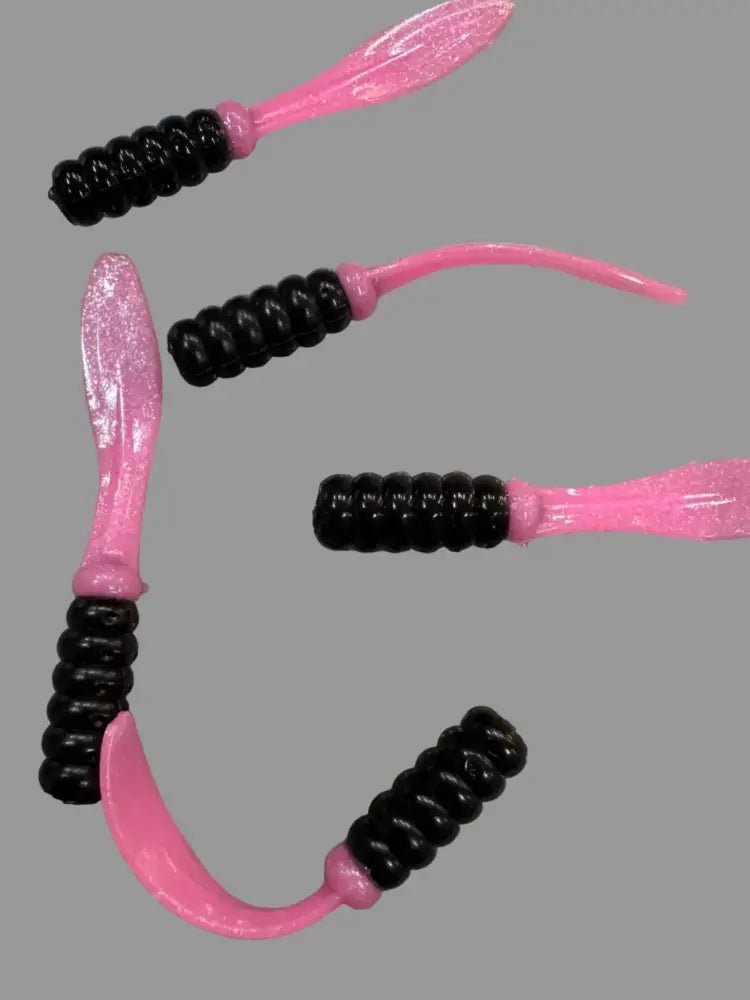 Soft plastic Crappie jigs 2 inches long with a Black head and pearl look pink flat beaver tail