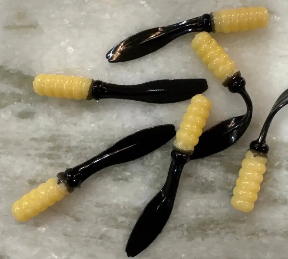 Soft plastic Crappie jig 2 inches long with a creamy white head and a black flat beaver tail