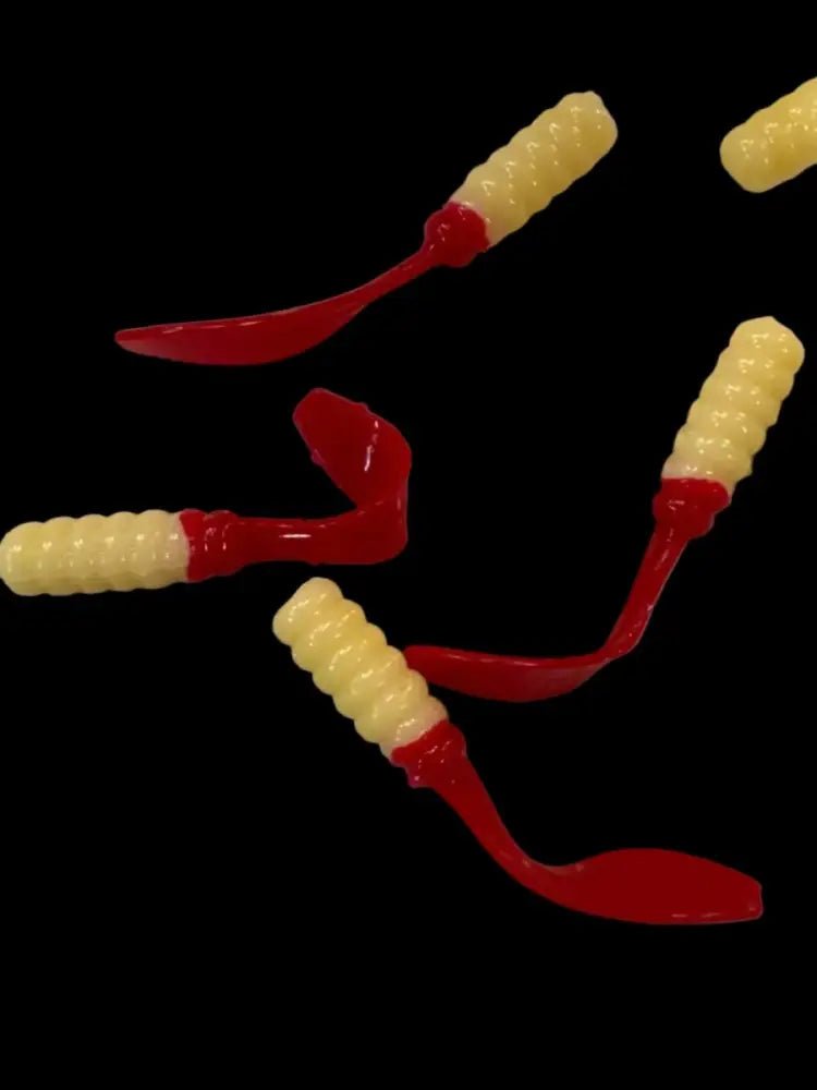 Soft plastic Crappie jig 2 inches long with a creamy white head and a translucent  cherry red flat beaver tail