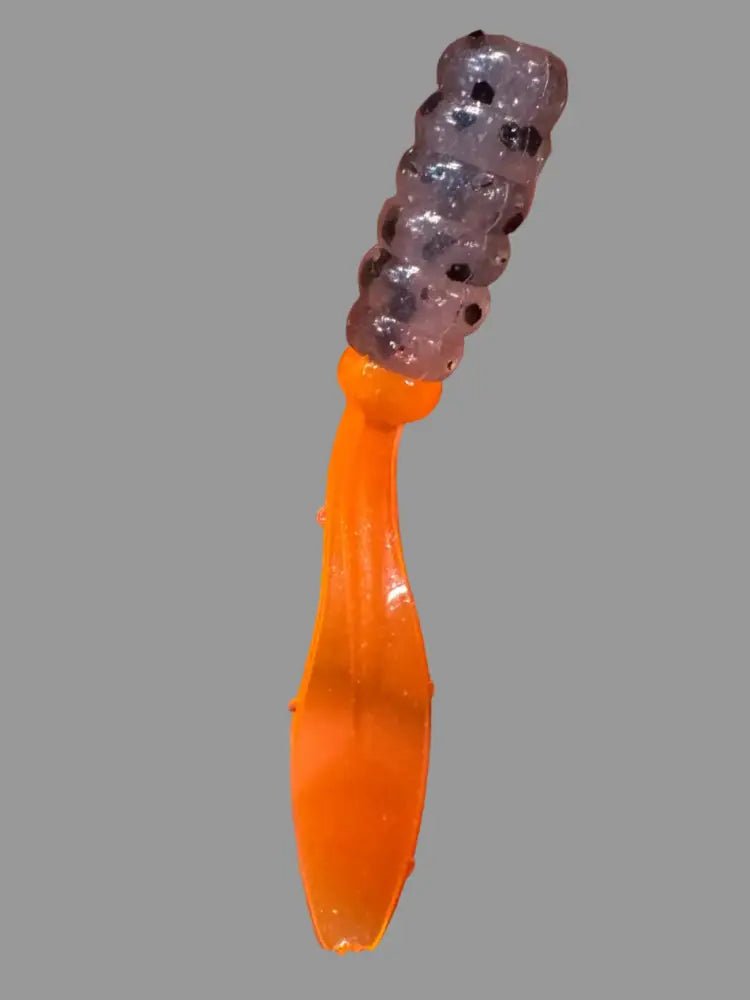 Soft plastic Crappie jig 2 inches long with a translucent clear head with a translucent orange flat beaver tail