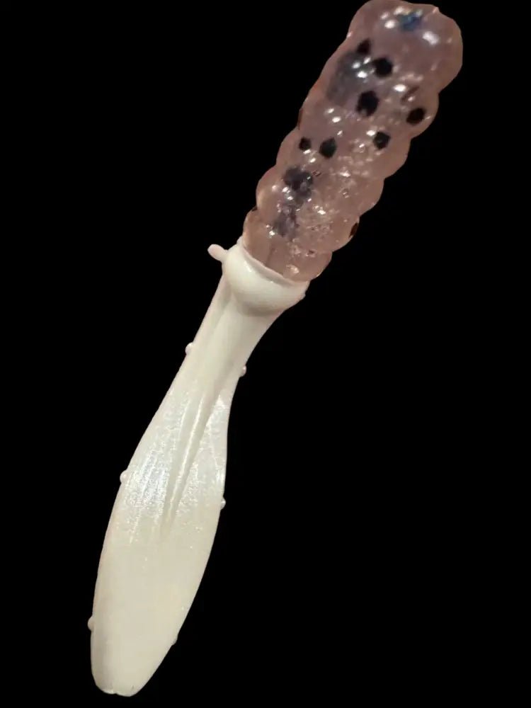 Soft plastic Crappie jig 2 inches long with a clear translucent head with black glitter and pearl white flat beaver tail