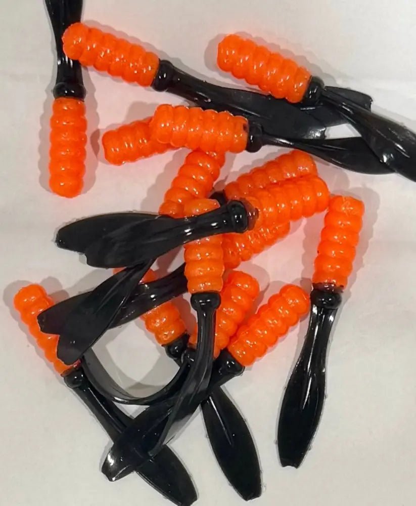 Soft plastic Crappie jig 2 inches long with a shiny orange head and black flat beaver tail